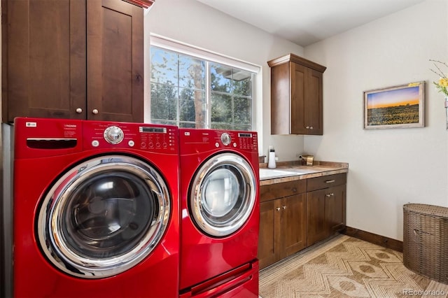 laundry room featuring cabinets and independent washer and dryer