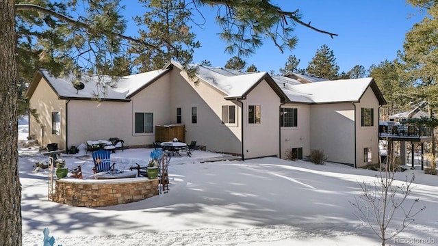 view of snowy exterior featuring a fire pit