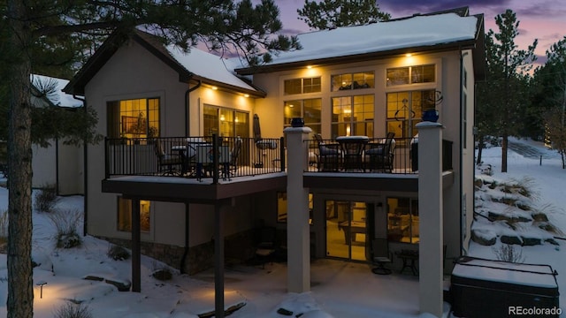 view of snow covered rear of property