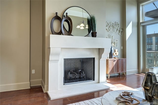 5455 Landmark Pl Unit 1403, Greenwood Village, CO 80111 - detailed view of wood finished floors, baseboards, and a fireplace with raised hearth