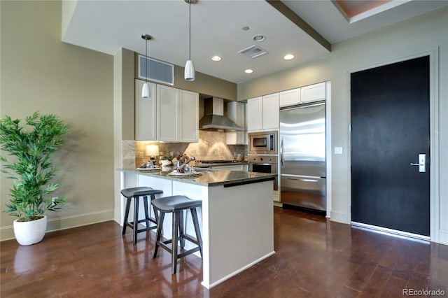 5455 Landmark Pl Unit 1403, Greenwood Village, CO 80111 - kitchen with built in appliances, wall chimney exhaust hood, a peninsula, white cabinets, and tasteful backsplash