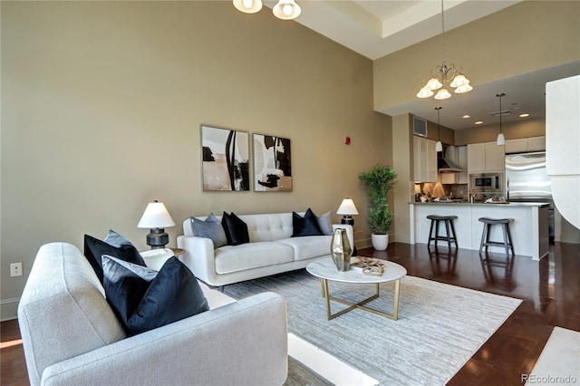 5455 Landmark Pl Unit 1403, Greenwood Village, CO 80111 - living area featuring a chandelier, a high ceiling, dark wood-type flooring, and baseboards
