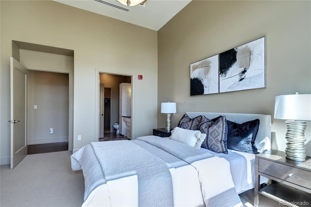 5455 Landmark Pl Unit 1403, Greenwood Village, CO 80111 - bedroom featuring connected bathroom, baseboards, and carpet