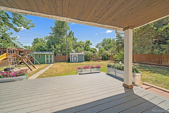 3324 W Hialeah Ave, Littleton, CO 80123 - wooden terrace featuring a storage unit, a fenced backyard, and a playground
