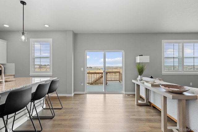 dining room featuring recessed lighting, light wood-style floors, and baseboards