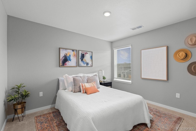 carpeted bedroom with visible vents and baseboards