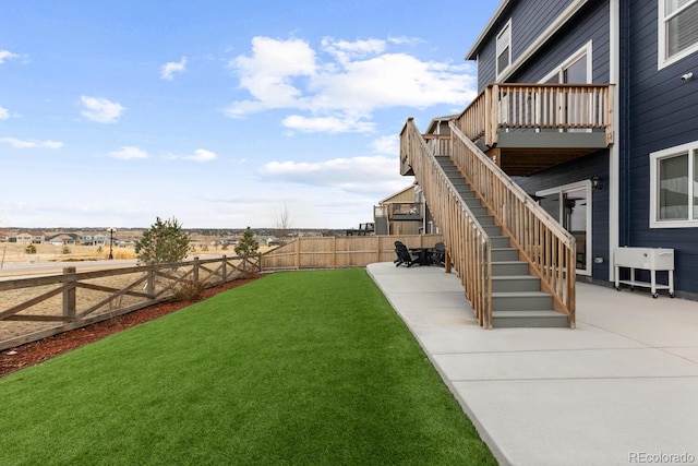 view of yard featuring stairway, a patio, and a fenced backyard