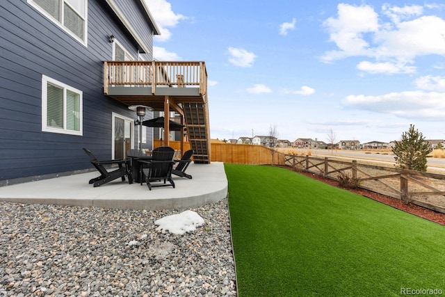 view of yard with a deck, a patio, stairs, and a fenced backyard