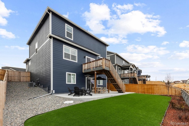 back of property with central air condition unit, a patio, a fenced backyard, a yard, and stairs