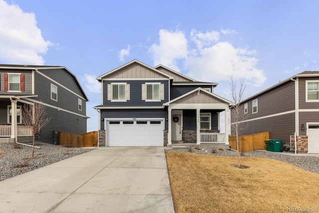 craftsman inspired home featuring stone siding, board and batten siding, covered porch, and driveway