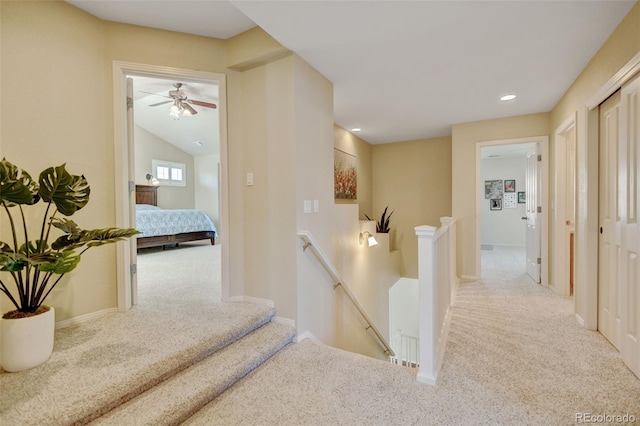 corridor featuring baseboards, carpet flooring, recessed lighting, and an upstairs landing
