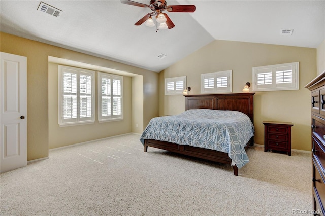 carpeted bedroom featuring vaulted ceiling, visible vents, and ceiling fan