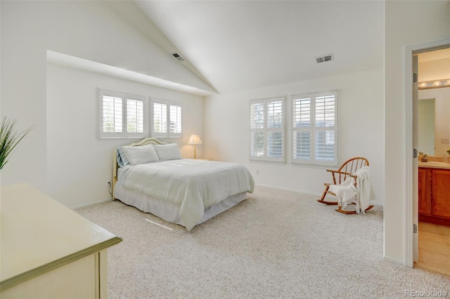 bedroom featuring lofted ceiling, light carpet, and visible vents