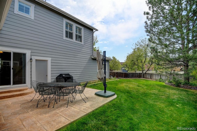 view of yard featuring entry steps, a patio, and a fenced backyard