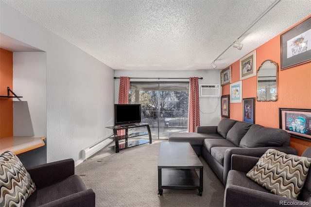 carpeted living room with a textured ceiling, a wall unit AC, and track lighting