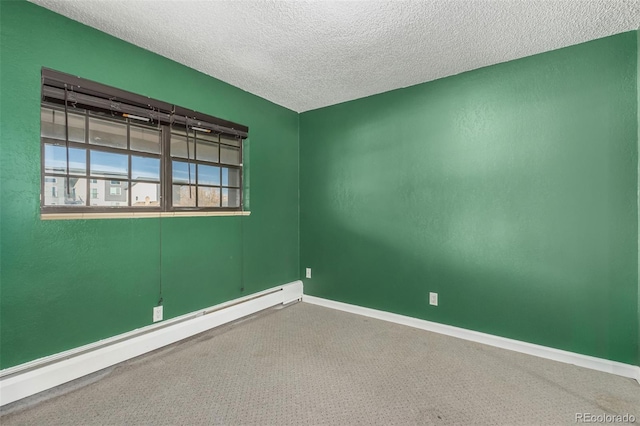 empty room with a textured ceiling and a baseboard radiator