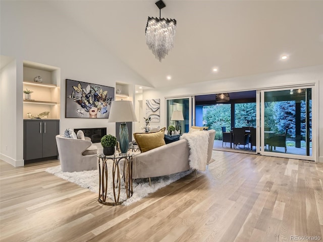 living area with light wood-type flooring, built in shelves, lofted ceiling, recessed lighting, and a chandelier