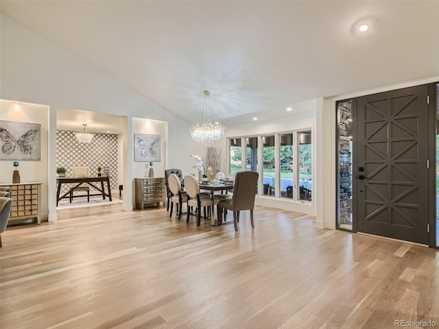 dining room featuring a chandelier, wood finished floors, recessed lighting, lofted ceiling, and baseboards