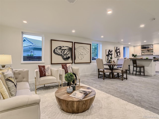 living area featuring baseboards and recessed lighting