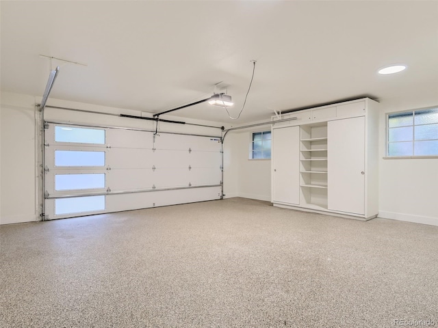 garage featuring a garage door opener and baseboards