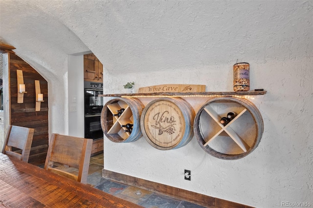 34 Amaranth Dr, Littleton, CO 80127 - room details with a textured wall, baseboards, and dobule oven black