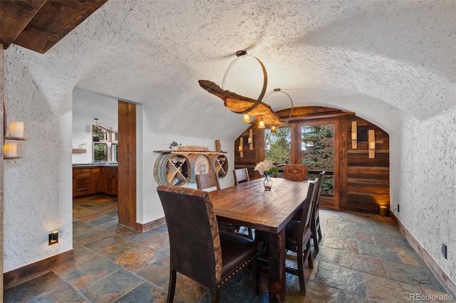 34 Amaranth Dr, Littleton, CO 80127 - dining room with stone tile floors, plenty of natural light, and vaulted ceiling