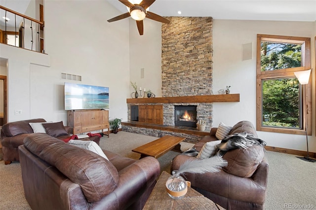 34 Amaranth Dr, Littleton, CO 80127 - carpeted living room featuring high vaulted ceiling, a stone fireplace, ceiling fan, baseboards, and visible vents