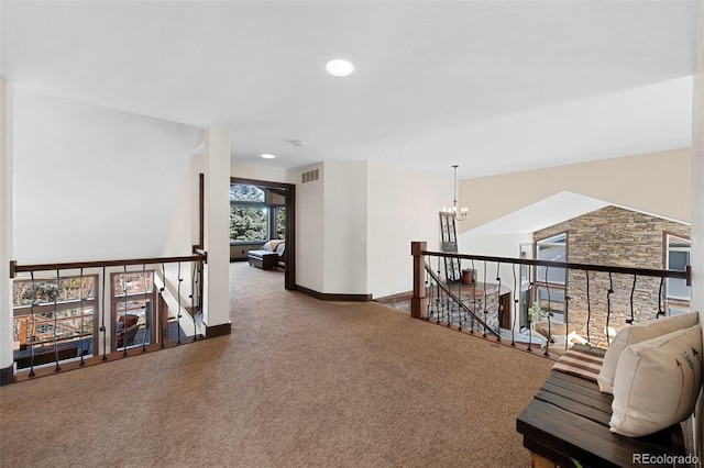 34 Amaranth Dr, Littleton, CO 80127 - hall with an upstairs landing, baseboards, a notable chandelier, carpet flooring, and visible vents