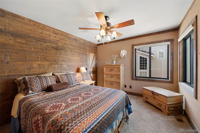 34 Amaranth Dr, Littleton, CO 80127 - carpeted bedroom featuring wooden walls, a ceiling fan, and baseboards