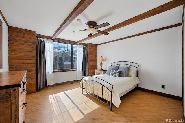 34 Amaranth Dr, Littleton, CO 80127 - bedroom with beamed ceiling, baseboards, and light wood finished floors