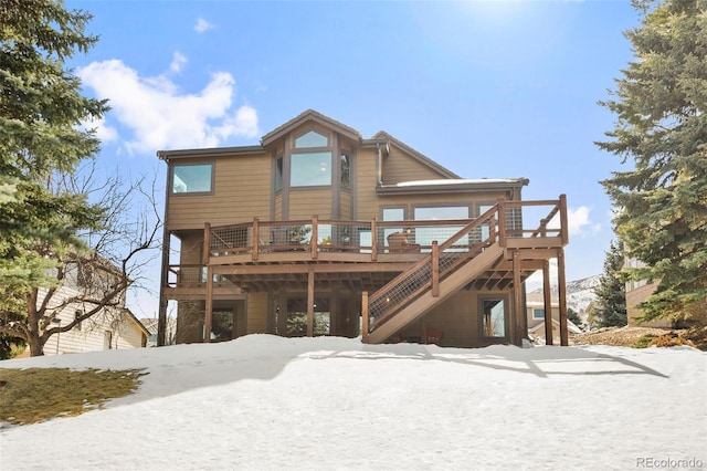 34 Amaranth Dr, Littleton, CO 80127 - snow covered property with a wooden deck and stairway