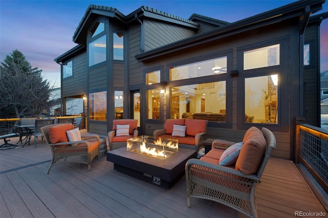 34 Amaranth Dr, Littleton, CO 80127 - deck at dusk featuring an outdoor living space with a fire pit