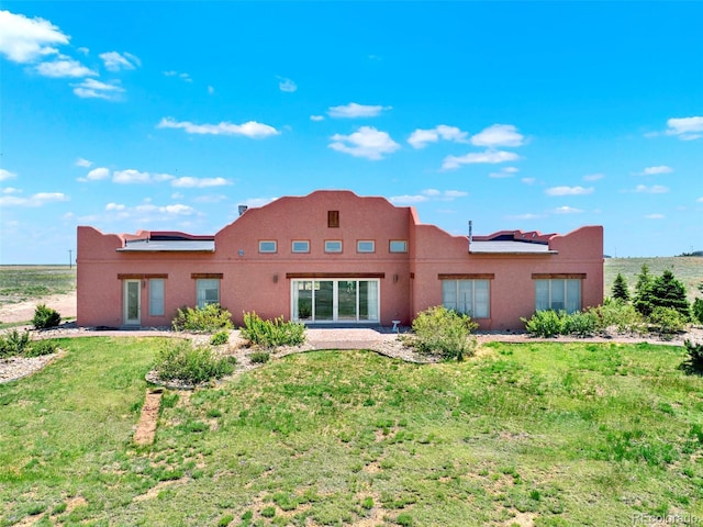 5549 Yulle Rd, Bennett, CO 80102 - rear view of property featuring stucco siding and a yard