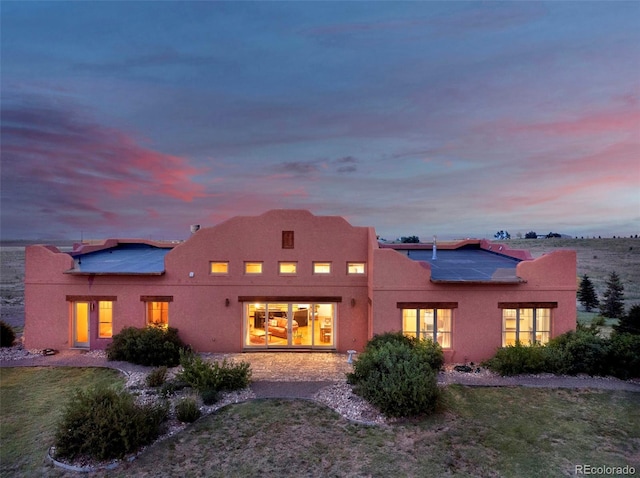 5549 Yulle Rd, Bennett, CO 80102 - back of property with roof mounted solar panels and stucco siding