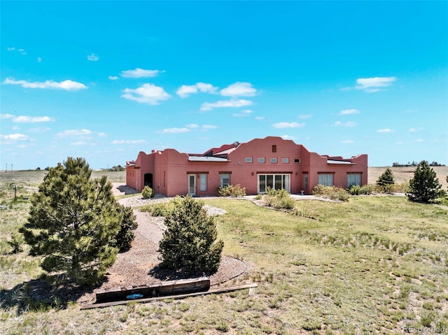 5549 Yulle Rd, Bennett, CO 80102 - back of property with stucco siding and a lawn