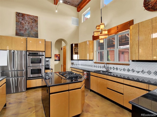 5549 Yulle Rd, Bennett, CO 80102 - kitchen featuring a towering ceiling, arched walkways, appliances with stainless steel finishes, backsplash, and dark countertops