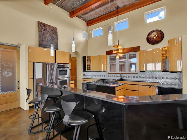 5549 Yulle Rd, Bennett, CO 80102 - kitchen with a high ceiling, dark countertops, backsplash, a breakfast bar, and beam ceiling