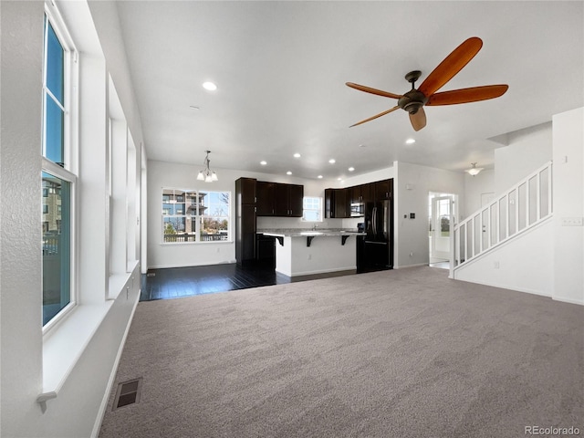 1826 Sunshine Ave, Longmont, CO 80504 - unfurnished living room featuring recessed lighting, dark carpet, healthy amount of natural light, and a ceiling fan