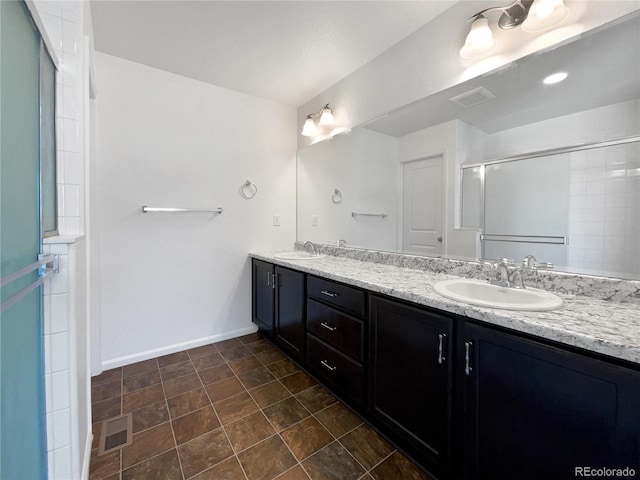 1826 Sunshine Ave, Longmont, CO 80504 - bathroom with double vanity, a shower with shower door, and baseboards
