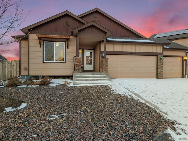 view of front of home featuring a garage, driveway, fence, and board and batten siding