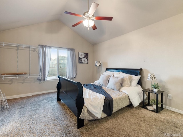 carpeted bedroom with vaulted ceiling, baseboards, and ceiling fan