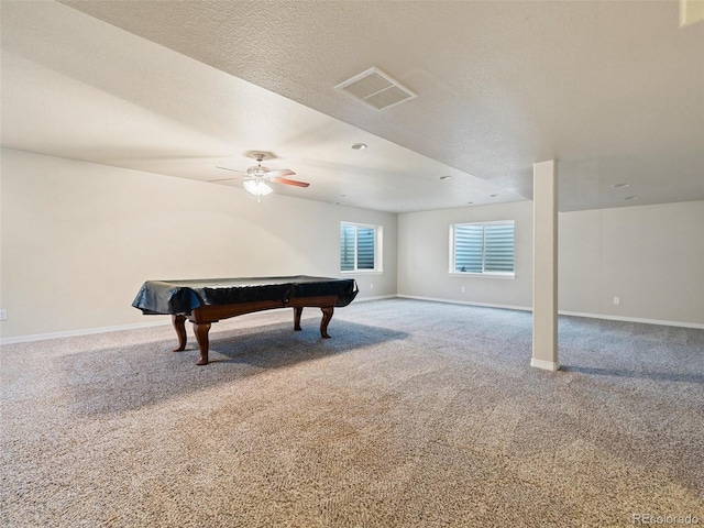 game room with a textured ceiling, carpet, visible vents, and baseboards