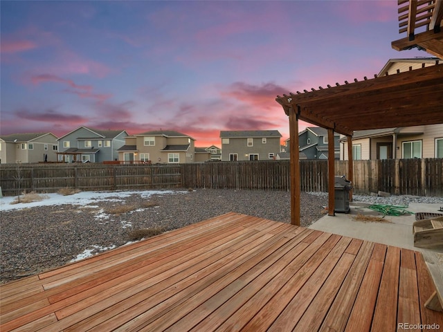 wooden deck featuring a residential view, a patio area, a fenced backyard, and a pergola