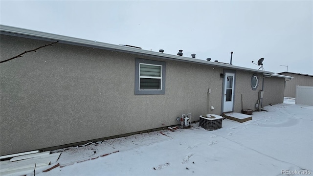 rear view of house with stucco siding