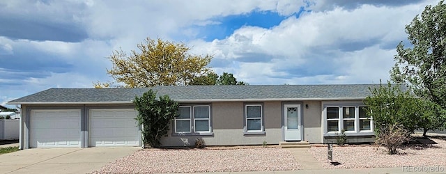 401 Gateway Ave, Fort Morgan, CO 80701 - ranch-style house featuring driveway, an attached garage, stucco siding, and a shingled roof