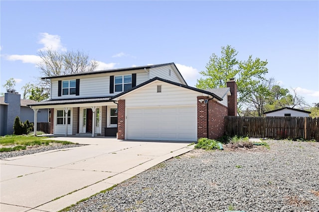 5199 Arbutus St, Arvada, CO 80002 - traditional-style home featuring driveway, fence, a porch, a garage, and brick siding