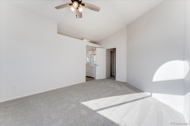 carpeted spare room featuring high vaulted ceiling and a ceiling fan