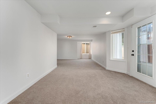 carpeted spare room featuring visible vents, recessed lighting, and baseboards