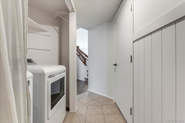 laundry room with laundry area, light tile patterned floors, and independent washer and dryer