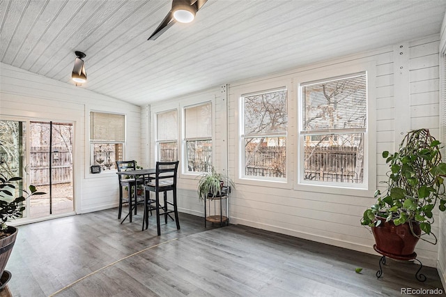 sunroom / solarium with a ceiling fan, wooden ceiling, and vaulted ceiling